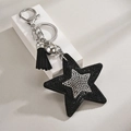 Detailed view of a black rhinestone star keychain with velvet tassels and metal hardware - Black