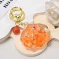 Llavero de concha marina con arena movediza líquida, rodajas de naranja y estrellas - Hebilla de Oro Claro + Concha Luminosa + Campana / Naranja