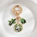 Cute panda and bamboo metal keychain with gold finish and green enamel pendants - Panda with Bamboo
