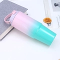 Detail of 30oz tumbler with pink to mint green gradient finish and portable handle - Pink and Green Gradient