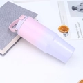 Close-up of a 30oz gradient pink and purple tumbler with handle and straw in lifestyle setting - Pink Purple Gradient