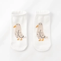 Detail of white cotton socks featuring a cute cartoon seagull pattern on a clean background - One Size / Pigeon