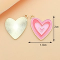 Detail of a 2x1.8cm heart pendant showing sunburst metal and pink enamel layers - Pink and Rose Red Heart