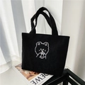 Detail of black corduroy tote bag with bear embroidery on a decorative magazine - Sheep Milk Tea Black