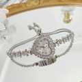 Elegant heart-shaped rhinestone watch with silver floral bracelet on reflective surface - Silver White Face