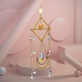 Close-up of golden geometric suncatcher with raw crystal and moon star charms - Citrine