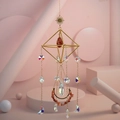Detailed close-up of golden suncatcher featuring red raw stone and rainbow crystal prism - Red Agate