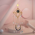 Detail of geometric sun catcher with gold metal frame, blue raw stone and crystal prism - Blue Sodalite