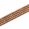 Macro shot of 10mm matte natural stone beads in earthy tones for DIY jewelry making - Electroplated Burgundy