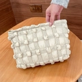 Detailed view of the cream bubble puffer grid texture and gold zipper on a canvas bag - Khaki