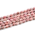 Macro detail of natural agate geode beads in pink with unique oval druzy textures - Red