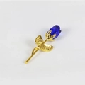 Elegant gold metal rose brooch featuring a faceted blue crystal bud on a white background - Gold Stem Blue Flower Loose