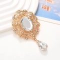 Vintage gold pendant with oval crystal and hollow lace design on white textured surface - Gold Base White Gem