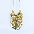 Close-up of golden metallic sequins on a stylish crossbody phone bag with chain links - Gold
