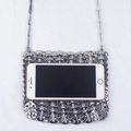 Detailed close-up of a silver chainmail crossbody bag showing size with a smartphone - Silver