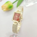 Elegant gold square watch with red dial and rhinestone-set metal strap on a floral backdrop - Gold Red