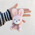 Close-up of a pink plush rabbit keychain with curly fur and a checkered bow tie detail - Pink / Lobster Clasp Keychain