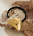 Detail of high-elastic black hair tie with gold textured heart on a stone base - Irregular Geometric