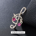 Luxurious gold music note brooch with pink rhinestones and white crystal accents - Double Pink Rhinestone Treble Clef Gold (XD9425)