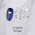 Macro shot of 5mm silver flower nail charm with iridescent rhinestone on blue nail - Silver Five-Petal Flower AB Rhinestone (6650)