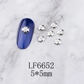 Detailed view of silver 5-petal flower nail charms with pearls on navy blue nail art - Silver Five-Petal Flower Pearl (6652)