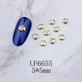 Macro shot of gold clover nail charms with clear rhinestones on marble surface - Gold Four-Leaf Clover White Rhinestone (6655)