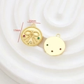 Macro detail of a 15mm gold bow pendant with red and green zircons for jewelry making - Colorful Zircon Bow