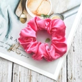 Elegant pink satin silk scrunchie on a magazine for a stylish hair accessory - Peach Pink