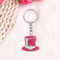 Pink glitter top hat keychain detail shown on a soft pink plush texture background - Green Rope Purple Hat