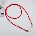Detailed macro view of red PU leather cord strap with golden lobster clasp connectors - Red + Gold Hook
