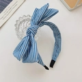 Chic blue and white striped bow headband made of soft fabric on a white display - Light Stripes