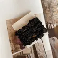 Close-up of black silk satin hair scrunchies on a nyu-nyu card with soft sheen texture - Four-Piece Set / Type A All Black