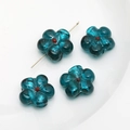 Macro detail of four blue glass flower beads with red centers and gold T-pin on white base - 7# Peacock Green Large Flower