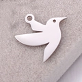 Minimalist silver bird pendant with polished mirror finish on beige velvet background - Hummingbird / Steel