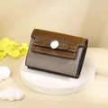 Close-up of bicolor leather card holder with litchi texture and silver buckle detail - Gray