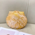 Detail of shell-shaped evening clutch in amber and cream resin with marble texture - Lemon Yellow