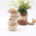 Set of three cylindrical wooden napkin rings decorated with natural jute rope bows - Large Medium Small Combination