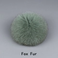 Macro shot of fluffy light green fox fur pom pom showing soft texture and natural hair detail - Fox Fur / Green