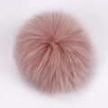 Close-up of soft pink real raccoon fur pompom accessory for hats and bags - Fox Fur / Dusty Pink