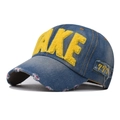 Macro detail of blue denim baseball cap featuring yellow fuzzy FAKE lettering embroidery - Adjustable / Yellow