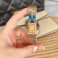 Close-up of golden padlock watch with mesh strap and blue protective film on the clasp - Full Gold Color