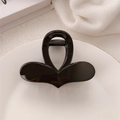 Dettaglio di una pinza per capelli nera a forma di fiocco su un piatto bianco - Lucido / Cuore Marrone Scuro