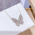 Macro view of butterfly pendant with purple zircon stones on a fine golden chain - Gold Purple