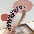 Close-up of handmade pink beaded headband with black leopard pattern and beige lining - 3cm Sponge Headband / Pink Leopard