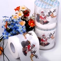 Detail view of printed toilet paper featuring Santa Claus and reindeer Christmas motifs - Santa Claus