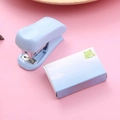 Mini light blue stapler set with 24/6 staples on a pink background for office use - Blue Series