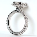 Macro detail of radiant cut halo ring with elaborate crown gallery and milgrain finish - US 10 / White Gold