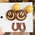 Détail d'élastiques à cheveux haute élasticité avec breloques smiley et bandes tressées - café