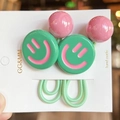 Macro shot of colorful smiley face charms on high-elastic green hair ties for women - 2 Pcs/Set / Emerald