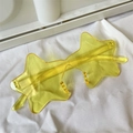 Detailed view of yellow star-shaped sunglasses with translucent resin frames and lenses - One-piece Star Yellow